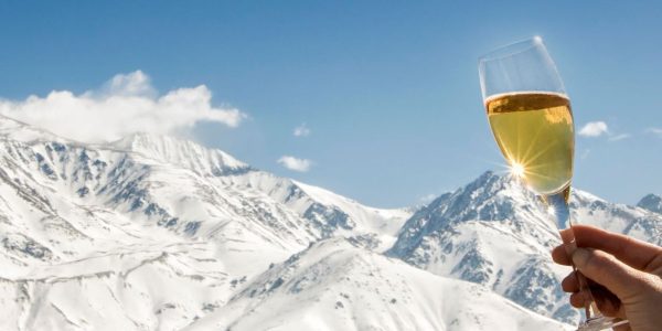Celebration with champagne at foot of the snowy Alps.