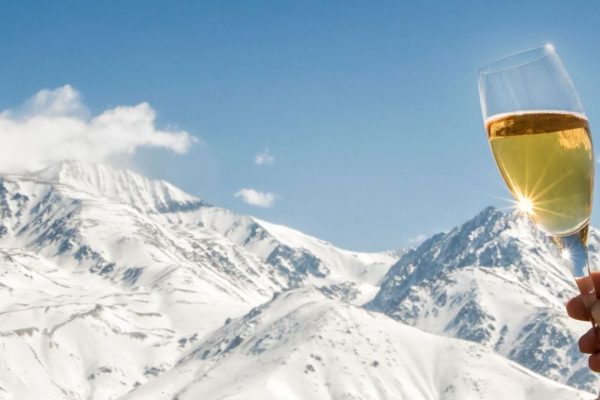 Celebration with champagne at foot of the snowy Alps.