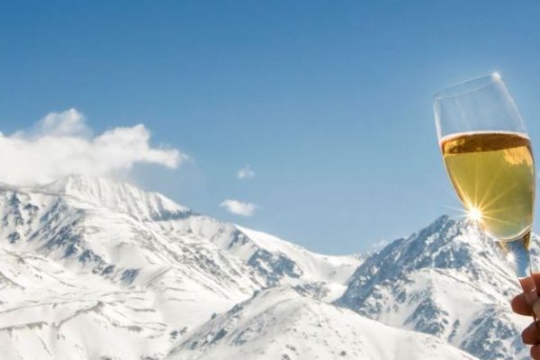Celebration with champagne at foot of the snowy Alps.