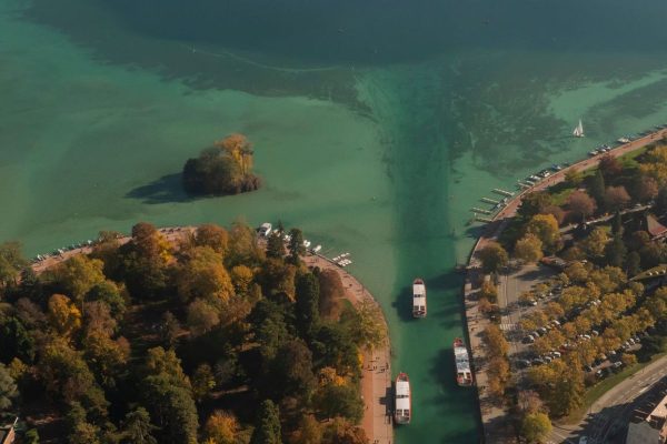 drone aerial view of France travel and landmarks. Romantic beautiful old town of famous destination Annecy town with medieval architecture building sunset