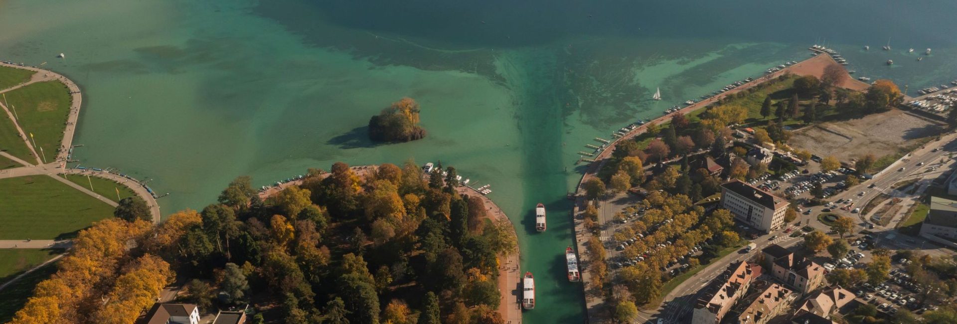 Drone aerial view of France travel and landmarks. Romantic, beautiful old town of the famous destination Annecy at sunset, with medieval architecture