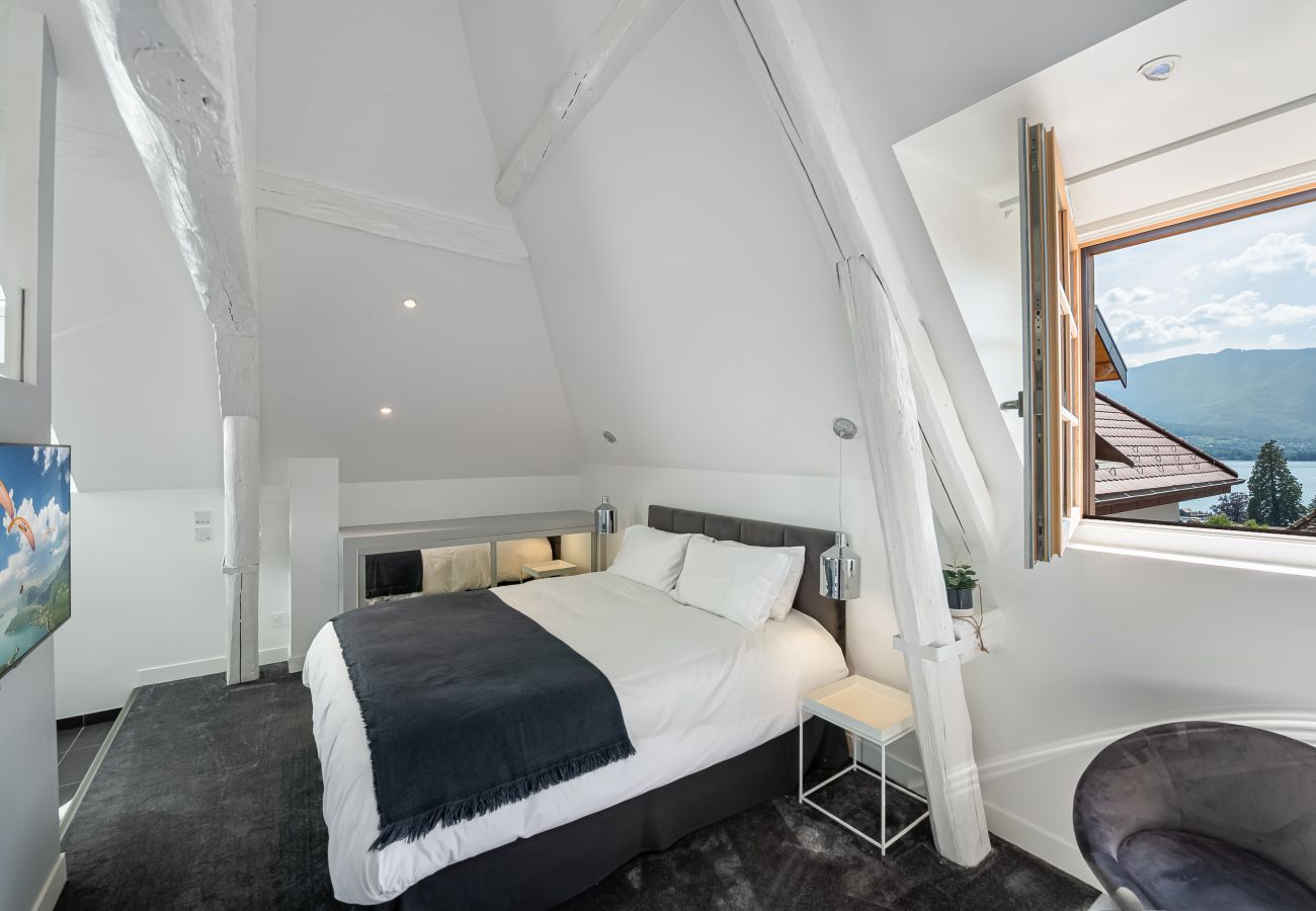 Master bedroom with lake view and bathroom.