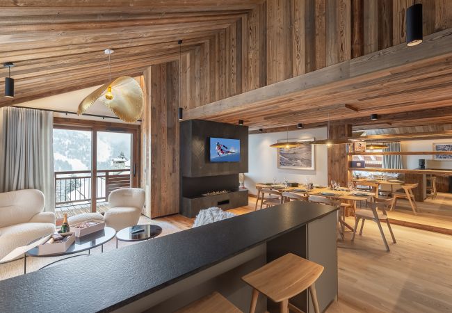 Luxurious dining room interior in our apartment in Meribel, with panoramic views of the mountains.