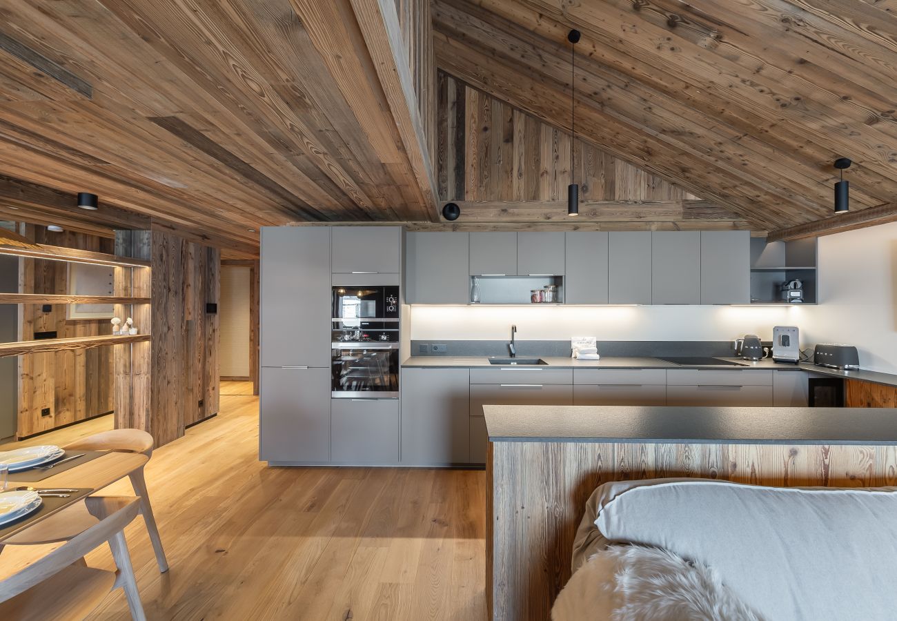 Luxurious Open Kitchen in the Heart of Méribel - Harmony between Living Room, Dining Area, and Culinary Facilities.